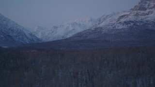 AK0001_2115 - 4K aerial stock footage flying by snow covered Talkeetna Mountains at twilight, Alaska
