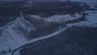 AK0001_2118 - 4K aerial stock footage snowy Matanuska River Valley, moon over Talkeetna Mountains, Alaska, twilight