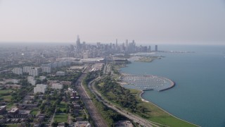 AX0001_014 - 4.8K aerial stock footage of the Downtown Chicago skyline and Lake Michigan, on a hazy day, Illinois