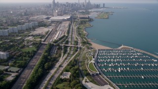 AX0001_016 - 4.8K aerial stock footage tilt from 31st Street Harbor and Highway 41, revealing Downtown Chicago skyline, on a hazy day, Illinois