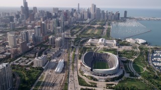 AX0001_021 - 4.8K aerial stock footage approach Downtown Chicago and tilt down on Soldier Field, Illinois