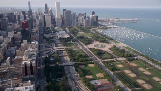 AX0001_023 - 4.8K aerial stock footage tilt from One Museum Park, revealing Grant Park and Downtown Chicago skyscrapers, on a hazy day, Illinois