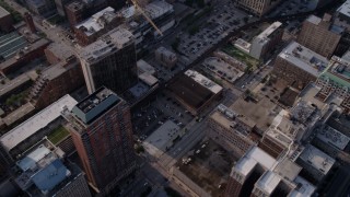 AX0001_024 - 4.8K aerial stock footage tilt up from downtown parking lots and buildings to reveal Willis Tower, Downtown Chicago, Illinois
