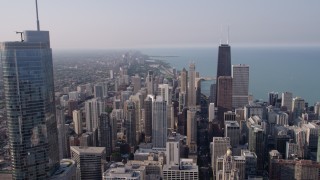 AX0001_028 - 4.8K aerial stock footage flying past Trump International toward John Hancock Center in Downtown Chicago, Illinois, on a hazy day