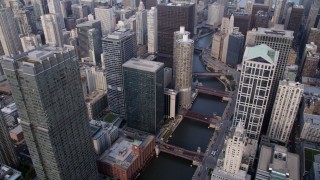 AX0001_047 - 4.8K aerial stock footage following the Chicago River through downtown skyscrapers toward Marina City, Downtown Chicago, Illinois