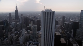 AX0001_051 - 4.8K aerial stock footage Orbiting Aon Center, with Downtown Chicago skyscrapers in the background, Illinois