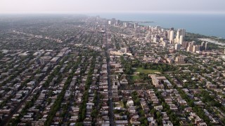 AX0001_058 - 4.8K aerial stock footage video of neighborhoods and apartment buildings in North Chicago, on a hazy day, Illinois