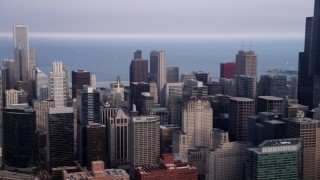 AX0001_068 - 4.8K aerial stock footage panning across Downtown Chicago on a hazy day to reveal Willis Tower, Illinois