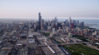 AX0001_077 - 4.8K aerial stock footage following the Chicago River toward Willis Tower and Downtown Chicago skyline, Illinois