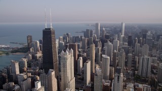 AX0001_088 - 4.8K aerial stock footage orbit John Hancock Center, revealing Downtown Chicago skyscrapers, on a hazy day, Illinois