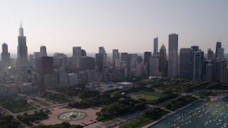 AX0001_101 - 4.8K aerial stock footage video tilt from Lake Michigan, revealing the harbor, Grant Park, and Downtown Chicago skyline, Illinois