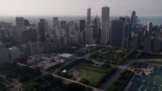 AX0001_102 - 4.8K aerial stock footage fly over Grant Park toward downtown skyscrapers, Downtown Chicago, Illinois