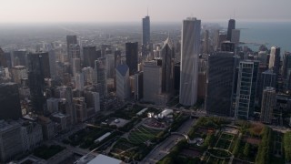 AX0001_103 - 4.8K aerial stock footage fly over Grant Park, and tilt to Cloud Gate sculpture and Jay Pritzker Pavilion, Downtown Chicago, Illinois