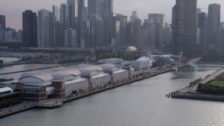 AX0001_126 - 4.8K aerial stock footage tilting up from Navy Pier to downtown Chicago skyscrapers, Illinois
