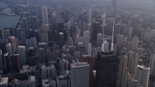 AX0001_127 - 4.8K aerial stock footage of the top of John Hancock Center and Downtown Chicago skyscrapers, on a hazy day, Illinois