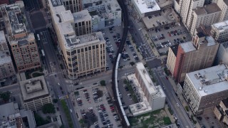 AX0001_145 - 4.8K aerial stock footage of a bird's eye view tracking an L Train through Downtown Chicago, Illinois