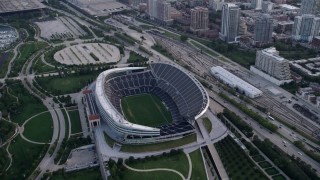 AX0001_152 - 4.8K aerial stock footage approach and tilt down to Soldier Field football stadium, Chicago, Illinois