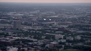 AX0001_155 - 4.8K aerial stock footage of White Sox Stadium surrounded by the city scape on a hazy day, Chicago, Illinois