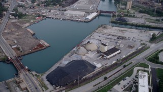 AX0001_163 - 4.8K aerial stock footage tilting up the Calumet River, revealing industrial buildings and bridges, East Side Chicago, Illinois