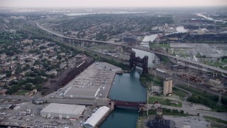 AX0001_164 - 4.8K aerial stock footage following Calumet River toward the High Bridge and Chicago Skyway, on a hazy day, Illinois