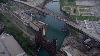 AX0001_165 - 4.8K aerial stock footage approach grain elevator between High Bridge and Chicago Skyway spanning Calumet River, East Side Chicago, Illinois