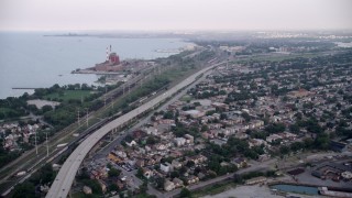 AX0001_166 - 4.8K aerial stock footage of bird's eye of grain elevation, tilt up to Chicago Skyway and freeway, East Side Chicago, Illinois
