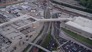 AX0001_172 - 4.8K aerial stock footage track a train between Ford Motor Company and parking lots, Hegewisch, Chicago, Illinois