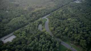 AX0001_174 - 4.8K aerial stock footage Torrence Avenue through the hazy Cook County Forest Preserve, Calumet City, Illinois