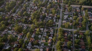 AX0001_176 - 4.8K aerial stock footage reverse view of a Lansing residential neighborhood, revealing Memorial Junior High School, Lansing, Illinois