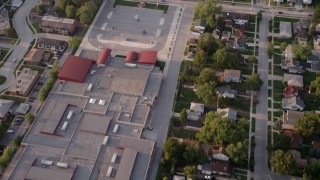 AX0001_177 - Aerial stock footage of 4.8K aerial  video reverse view of Memorial Junior High School, revealing homes in Lansing, Chicago, Illinois