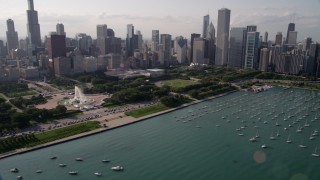 AX0002_005 - 4.8K aerial stock footage tilt from boats in the harbor to reveal Grant Park and Downtown Chicago, Illinois