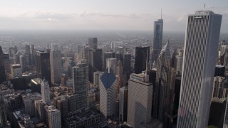 AX0002_008 - 4.8K aerial stock footage flying by Aon Center toward skyscrapers around Chicago River, Downtown Chicago, Illinois