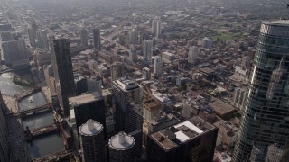 AX0002_010 - 4.8K aerial stock footage flying over the Chicago River and skyscrapers by Trump International Hotel and Tower, Downtown Chicago, Illinois