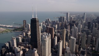AX0002_015 - 4.8K aerial stock footage an orbit of John Hancock Center, with the Downtown Chicago cityscape in the background, Illinois