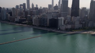 AX0002_022 - 4.8K aerial stock footage tilt from Lake Michigan revealing John Hancock Center and Downtown Chicago skyscrapers, Illinois