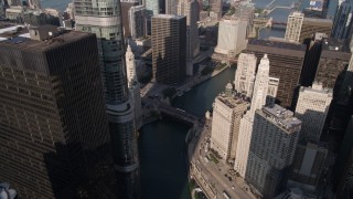 AX0002_040 - 4.8K aerial stock footage of following the Chicago River past 321 North Clark and Marina City in Downtown Chicago, Illinois