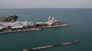 AX0002_044 - 4.8K aerial stock footage of flying by the side of Navy Pier on Lake Michigan, Chicago, Illinois
