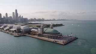 AX0002_045 - 4.8K aerial stock footage of orbiting the end of Navy Pier, revealing the Downtown Chicago skyline, Illinois