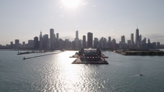 AX0002_046 - 4.8K aerial stock footage of a reverse view of Navy Pier and the Downtown Chicago skyline seen from Lake Michigan, Illinois