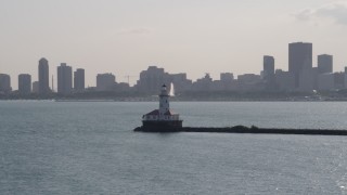 AX0002_048 - 4.8K aerial stock footage of an orbit of Chicago Harbor Lighthouse with Downtown Chicago skyline in the background, Illinois