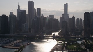 AX0002_051 - 4.8K aerial stock footage approach skyline and bridge over Chicago River, with sun reflecting on water, Downtown Illinois