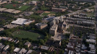 AX0002_060 - 4.8K aerial stock footage of orbiting a football field at St. Ignatius College Prep in West Side Chicago, Illinois