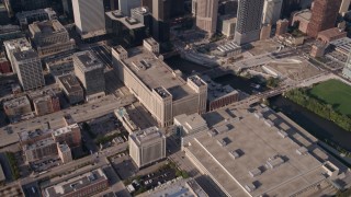AX0002_065 - 4.8K aerial stock footage tilt up from buildings to reveal Willis Tower and Downtown Chicago cityscape, Illinois