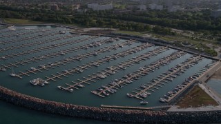 AX0002_090 - 4.8K aerial stock footage approach 31st Street Harbor and fly over boats in the docks, Chicago, Illinois