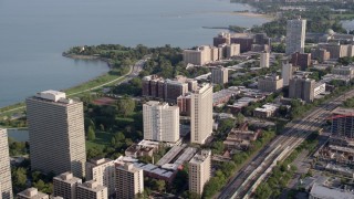 AX0002_095 - 4.8K aerial stock footage of flying by apartment buildings on the shore of Lake Michigan, Hyde Park, Chicago, Illinois