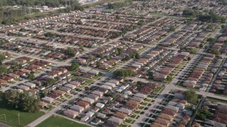 AX0002_105 - 4.8K aerial stock footage of flying over rows of suburban homes in Lansing, Illinois