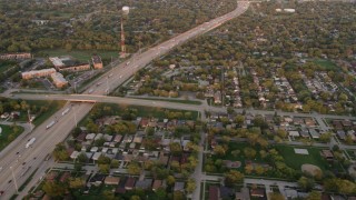 AX0003_003 - 4.8K aerial stock footage of flying over residential neighborhoods and Kingery Expressway in Lansing, at sunset, Illinois