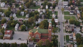 AX0003_006 - 4.8K aerial stock footage of flying over residential neighborhood, tilt to church, at sunset, Calumet City, Illinois