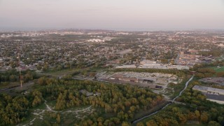 AX0003_008 - 4.8K aerial stock footage of a Hammond residential neighborhood and warehouse buildings, on a hazy day, at sunset, Hammond, Indiana