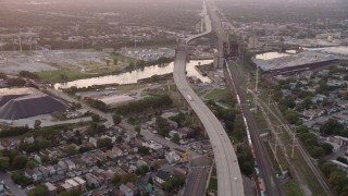 AX0003_012 - 4.8K aerial stock footage tilt to reveal the Chicago Skyway and High Bridge spanning the Calumet River at twilight, Illinois